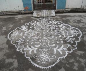 Different kolam in white. Flowers.