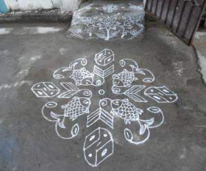 Rangoli: Fish kolam in white.