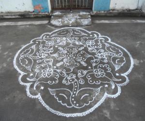 Flying swans & flowers. Kolam in white.