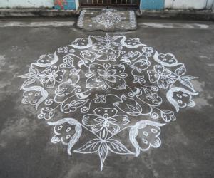 Rangoli: kolam in white. Flowers & leaves.