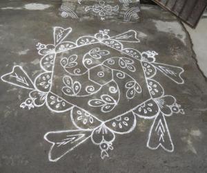 Heart birds kolam in white.