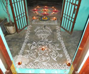 On karthigai, simple kolam with borders, poo decoration & kolam with deepam.