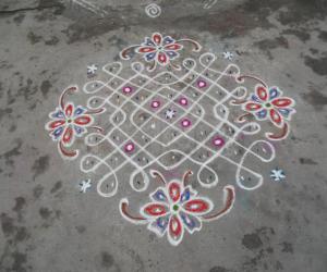 A simple Chikku Kolam with flowers.