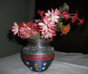 Clay pot craft with silk thread as flower vase.