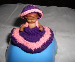 A simple doll, covered with crochet skirt & cap.