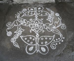 A small butterfly kolam in white.