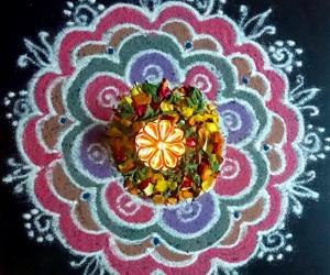 Pooja kolam freehand with flowers n colours.