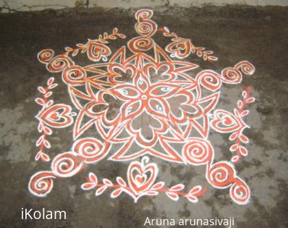 Rangoli: orange colour kolam.