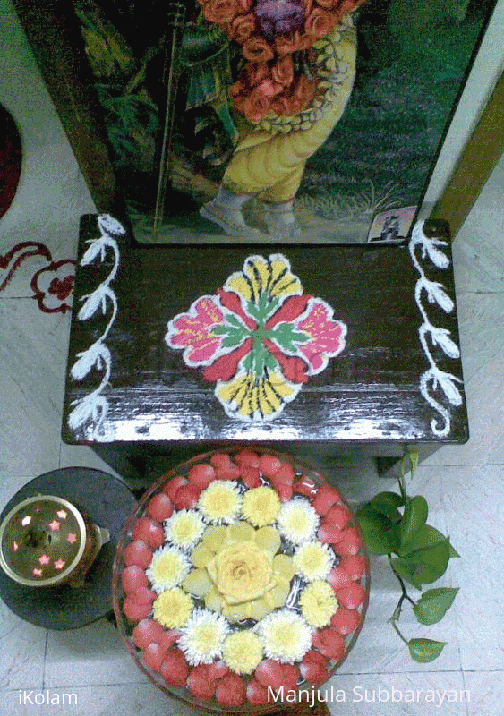 Rangoli: Glass bowl filled with water and flowers