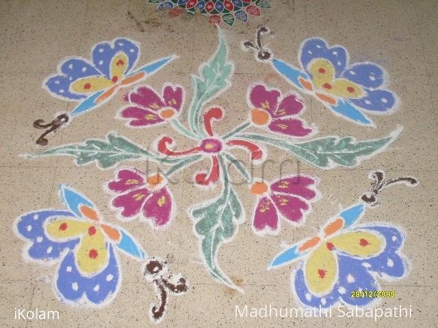 Rangoli: Butterflies on flowers.