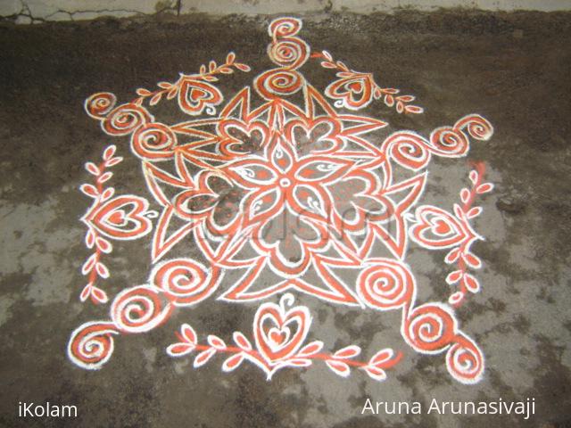 Rangoli: orange colour kolam.