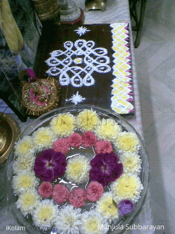 Rangoli: Glass bowl filled with water and flowers