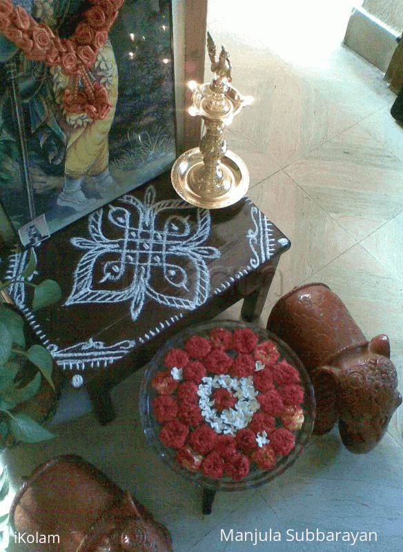 Rangoli: Glass bowl filled with water and flowers