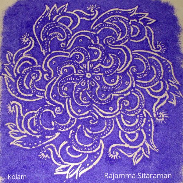 Rangoli: white kolam on violet base.