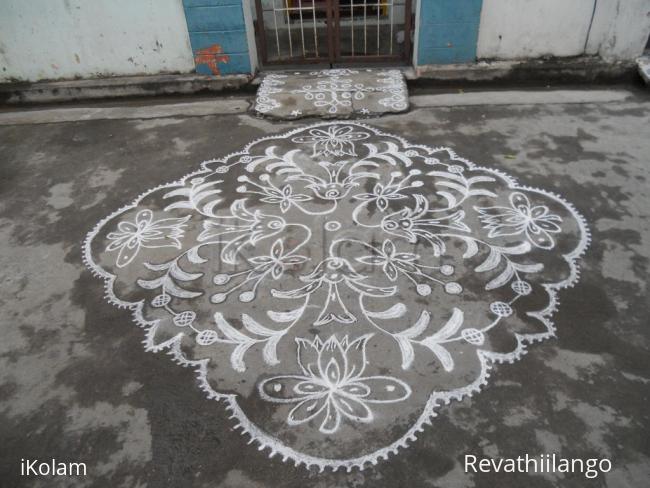 Rangoli: Different kolam in white. Flowers.