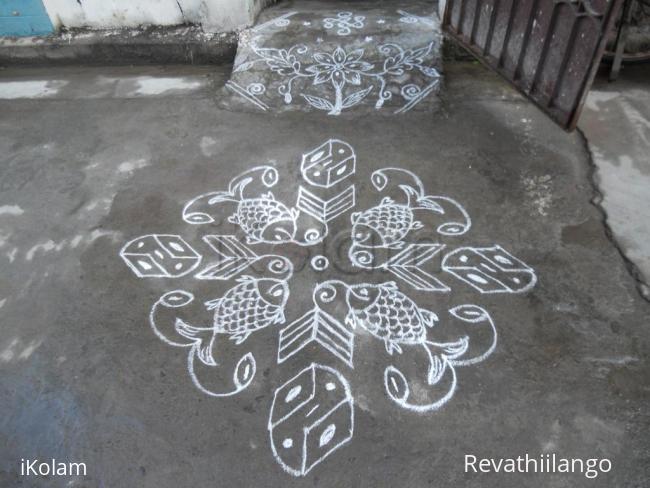 Rangoli: Fish kolam in white.