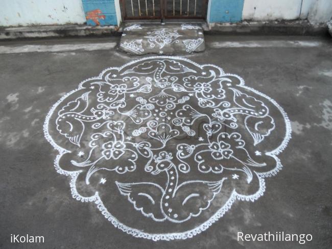 Rangoli: Flying swans & flowers. Kolam in white.