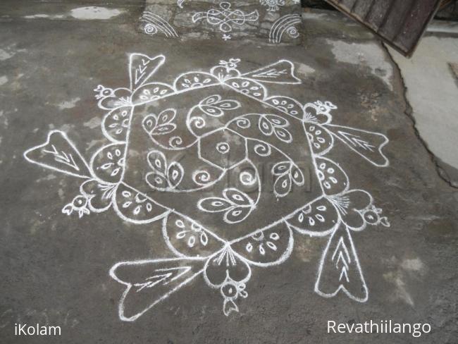 Rangoli: Heart birds kolam in white.