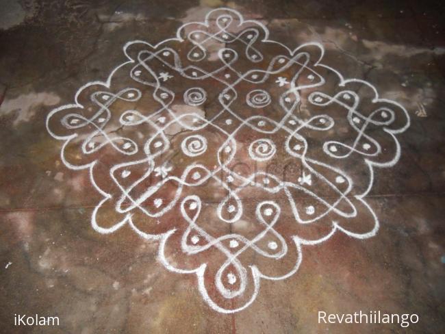 Rangoli: Chikku kolam in white.