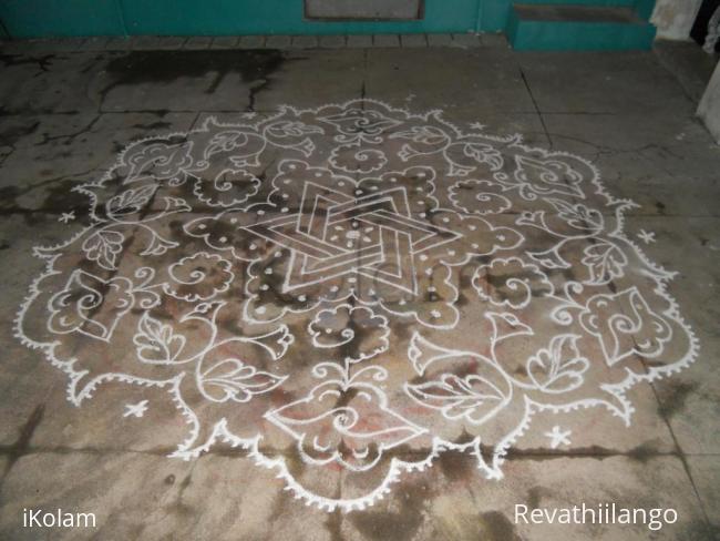 Rangoli: Star & bitterguard kolam in white.