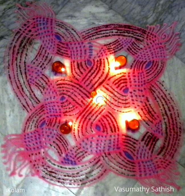 Rangoli: Padi kolam with rice batter mixed with red liquid colour.