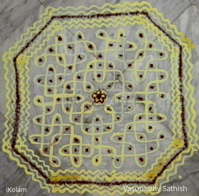 Rangoli: Chikku kolam with rice batter mixed with haldi. Dot count 11 dots 3 lines till 3  straight dots.