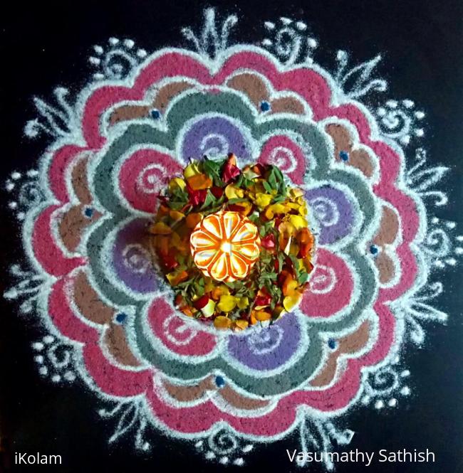 Rangoli: Pooja kolam freehand with flowers n colours.