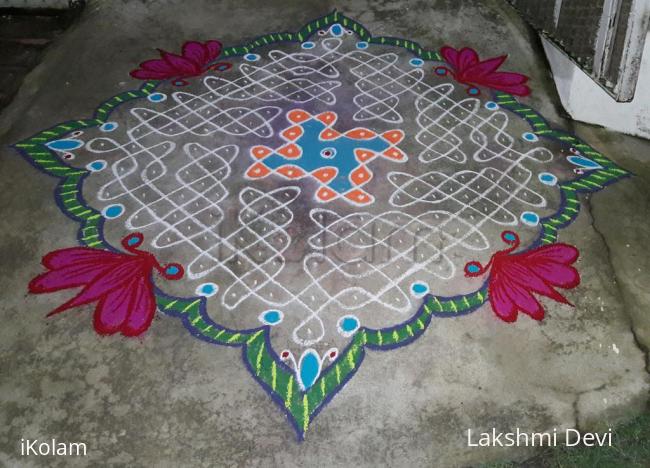 Rangoli: chikku kolam with colourful border.